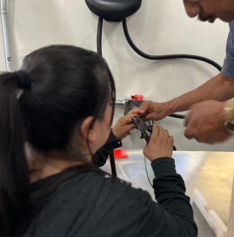 Trainees connecting an EV charger